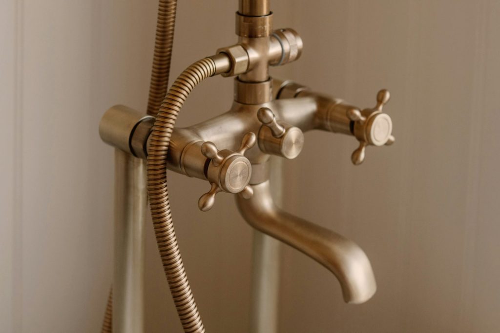 Antique brass bathtub faucet with handheld showerhead